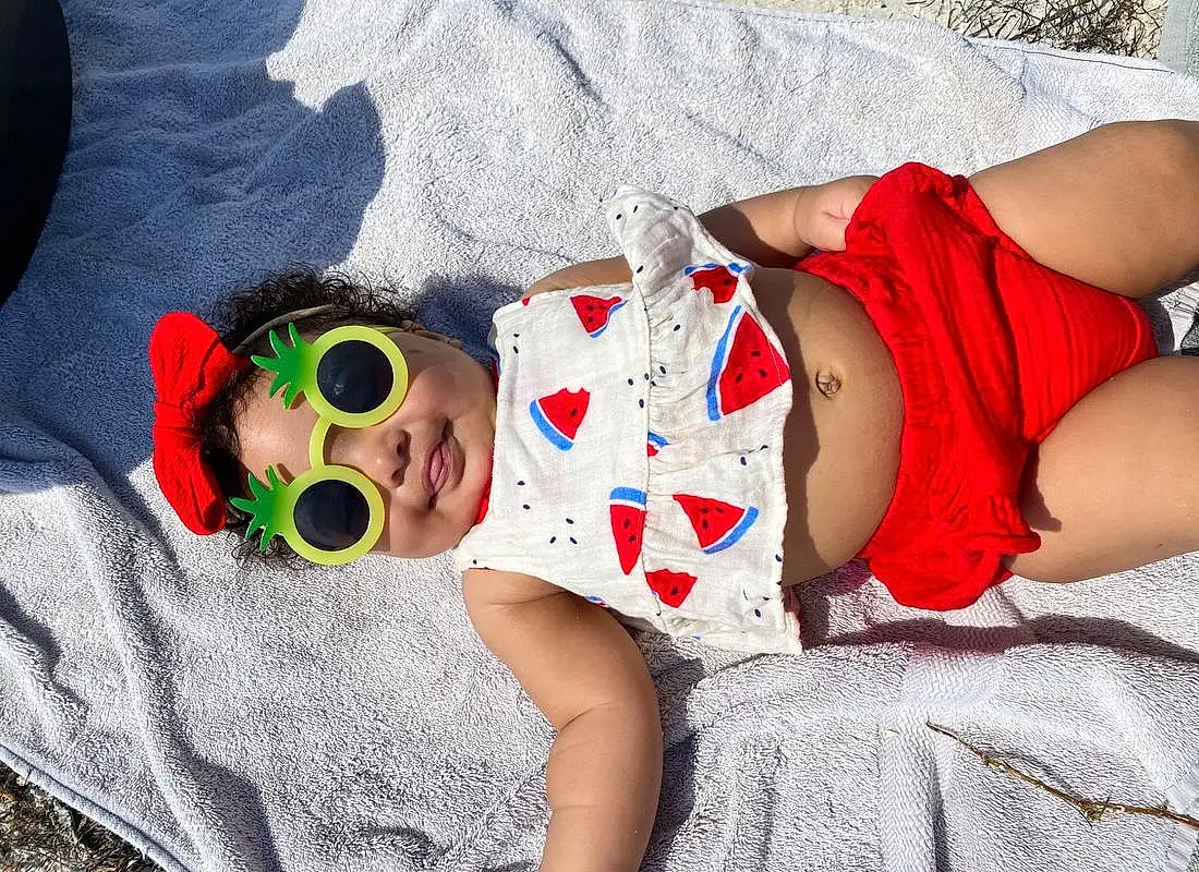 Skin, Glasses, Facial Expression, Hat, Sunglasses, Textile, Baby & Toddler Clothing, Dress, Happy, Grass, Goggles, Cool, Eyewear, Headgear, Thigh, Summer, Fun, Beauty, Toddler, Child, Person