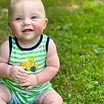 Face, Cheek, Skin, Head, Eyes, Smile, People In Nature, Green, Baby & Toddler Clothing, Happy, Grass, Plant, Toddler, Leisure, Meadow, Groundcover, Baby, Fun, Sitting, Person