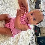Skin, Arm, Dress, Textile, Smile, Happy, Pink, Baby & Toddler Clothing, Baby, Finger, Toddler, People, Fun, Thigh, Child, Human Leg, Foot, Abdomen, Baby Products, Pattern, Person, Surprise