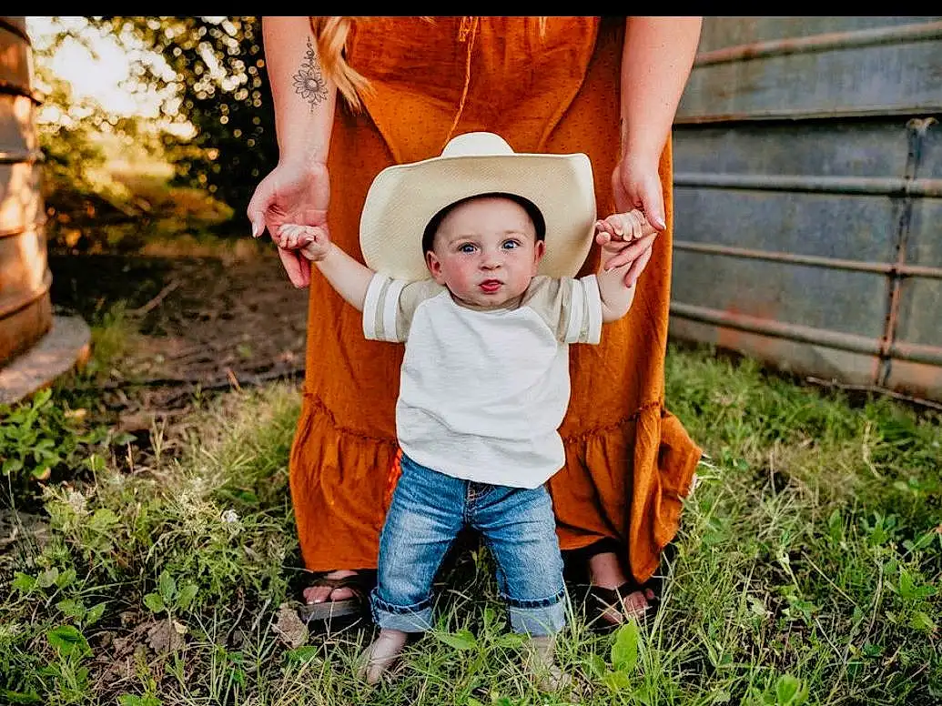 Clothing, Jeans, Plant, Leg, People In Nature, Dress, Flash Photography, Hat, Happy, Sunlight, Grass, Tree, Headgear, Sun Hat, Leisure, Toddler, Baby, Grassland, Fun, Person