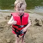 Water, People In Nature, Beach, Sleeve, Body Of Water, Summer, Toddler, Fun, T-shirt, Leisure, Baby & Toddler Clothing, People On Beach, Child, Personal Protective Equipment, Grass, Shore, Happy, Sand, Thigh, Knee, Person