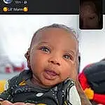 Skin, Smile, Flash Photography, Sleeve, Gesture, Happy, Baby, Toddler, Child, Fun, T-shirt, Thumb, Photo Caption, Gadget, Sitting, Multimedia, Selfie, Baby Products, Display Device, Person