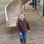 Jeans, Smile, Plant, Tree, Fun, Jacket, Leisure, Toddler, Playground, Recreation, Grass, Chute, Shade, Outdoor Play Equipment, Soil, Child, Road Surface, Play, Playground Slide, Person, Joy