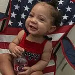 Cheek, Skin, Smile, Eyes, Human Body, Textile, Baby & Toddler Clothing, Thigh, Baby, Happy, Toddler, Lap, Fun, Human Leg, Child, Thumb, Flag Of The United States, Pattern, Event, Foot, Person, Joy