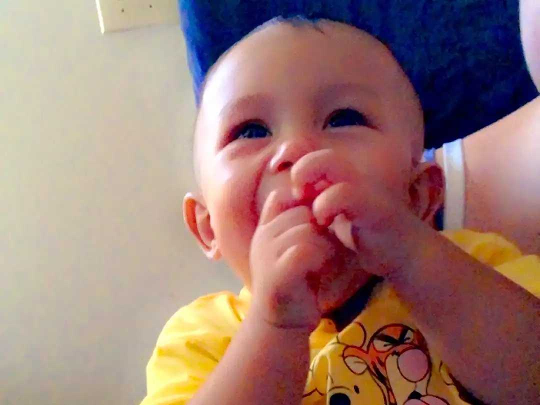 Nose, Face, Cheek, Skin, Lip, Chin, Mouth, Eyes, Human Body, Smile, Neck, Baby, Iris, Happy, Gesture, Finger, Baby & Toddler Clothing, Thumb, Toddler, Nail, Person