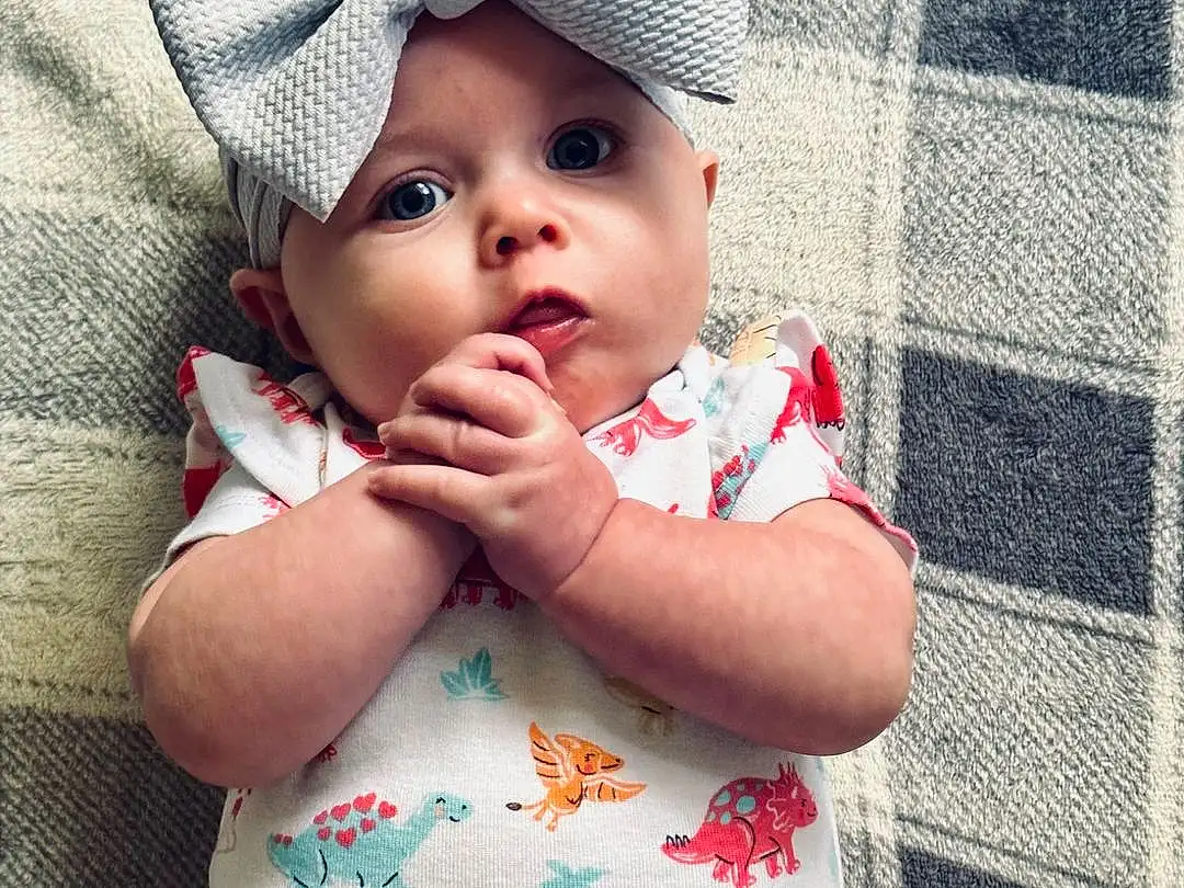 Face, Skin, Lip, Hand, Photograph, Eyes, Facial Expression, Cap, Baby & Toddler Clothing, Textile, Sleeve, Happy, Pink, Toddler, Baby, Smile, Comfort, Red, Thigh, Person, Headwear