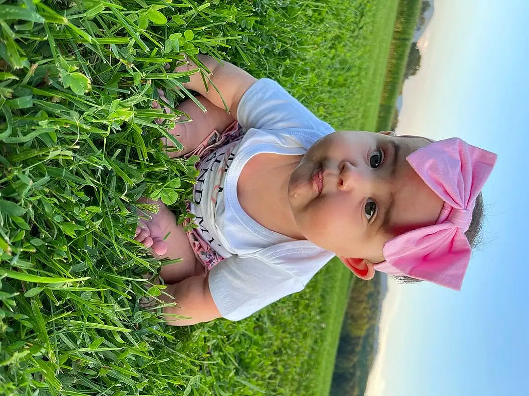 Skin, Plant, People In Nature, Grass, Smile, Happy, Toddler, Sky, Groundcover, Hat, Baby & Toddler Clothing, Leisure, Tree, Baby, Grassland, Child, Fun, Garden, Herb, Shrub, Person, Headwear