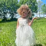Clothing, Cloud, Sky, Plant, Dress, Tree, People In Nature, Flash Photography, Happy, Sunlight, Grass, Fawn, Gown, Bridal Clothing, Bridal Party Dress, Grassland, Meadow, Day Dress, Long Hair, Toddler, Person