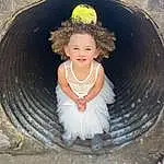 Hair, Smile, Head, Chin, Hairstyle, Eyes, Flash Photography, Dress, Happy, Toddler, Fun, Baby & Toddler Clothing, Wood, Leisure, Automotive Tire, Grass, Sitting, Circle, Child, Soil, Person, Joy