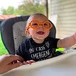 Glasses, Goggles, Vision Care, Sunglasses, Sleeve, Eyewear, Happy, Toddler, T-shirt, Personal Protective Equipment, Fun, Child, Baby & Toddler Clothing, Sitting, Recreation, Smile, Chair, Vacation, Leisure, Room, Person