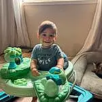 Smile, Comfort, Toddler, Baby, Window, Leisure, Curtain, Toy, Fun, Baby & Toddler Clothing, Child, Sitting, Happy, Baby Playing With Toys, Baby Products, Shorts, T-shirt, Room, Play, Person, Joy