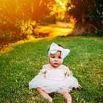 Plant, Photograph, Light, People In Nature, Flash Photography, Tree, Botany, Happy, Orange, Sunlight, Grass, Baby, Red, Summer, Toddler, Baby & Toddler Clothing, Grassland, Meadow, Landscape, Person, Headwear