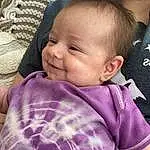 Cheek, Skin, Chin, Smile, Purple, Textile, Sleeve, Iris, Pink, Comfort, Happy, Toddler, Baby, Baby & Toddler Clothing, Child, Beauty, Grass, Magenta, Linens, Pattern, Person, Joy