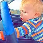 Hand, Vehicle, Blue, Car, Human Body, Window, Automotive Design, Baby & Toddler Clothing, Steering Wheel, Finger, Vehicle Door, Automotive Exterior, Vroom Vroom, Car Seat Cover, Steering Part, Leisure, Car Seat, Toddler, Fun, Person
