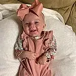 Face, Cheek, Skin, Head, Smile, Comfort, Baby & Toddler Clothing, Textile, Sleeve, Happy, Dress, Collar, Pink, Baby, Toddler, Linens, Fashion Accessory, Baby Products, Pattern, Child, Person
