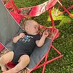 Chair, Shorts, Grass, Leisure, Folding Chair, Plant, Toddler, Fun, Lawn, People In Nature, Recreation, T-shirt, Sitting, Carmine, Tree, Child, Magenta, Lap, Outdoor Furniture, Person