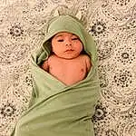 Child, Green, Baby, Skin, Baby Products, Textile, Smile, Linens, Toddler, Person, Headwear