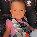 Skin, Joint, Smile, Comfort, Automotive Design, Thigh, Car Seat, Finger, Pink, Flash Photography, Car Seat Cover, Vehicle Door, Toddler, Lap, Auto Part, Baby, Steering Wheel, Knee, Human Leg, Sitting, Person