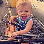 Skin, Smile, Hairstyle, Photograph, Eyes, Hood, Leg, Yellow, Toddler, Cool, Thigh, Happy, Shopping Cart, Child, Automotive Lighting, Chair, Personal Luxury Car, Automotive Tire, Beauty, Person, Joy