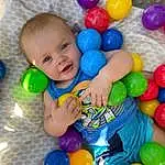 Smile, Photograph, Toy, Yellow, Baby Playing With Toys, Happy, Fun, Red, Toddler, Child, Leisure, Ball Pit, Balloon, Baby, Event, Play, Party Supply, Plastic, Person