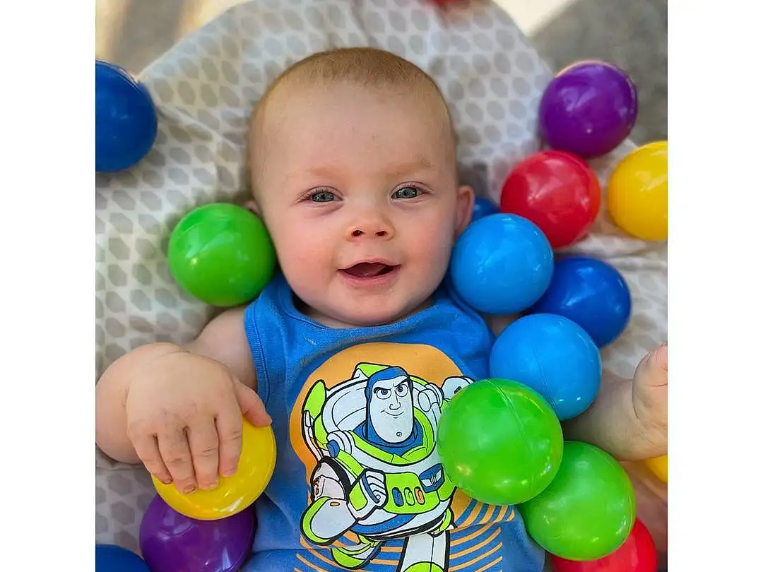 Smile, Baby Playing With Toys, Happy, Toy, Toddler, Baby & Toddler Clothing, Baby, Ball Pit, Child, Fun, Baby Products, Event, Play, Baby Toys, Electric Blue, Party Supply, Font, T-shirt, Balloon, Person