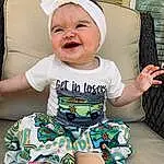 Clothing, Face, Smile, Skin, Head, Facial Expression, Baby & Toddler Clothing, Comfort, Sleeve, Baby, Happy, T-shirt, Baby Laughing, Cool, Toddler, Child, Sitting, Pattern, Thigh, Fun, Person, Joy, Headwear