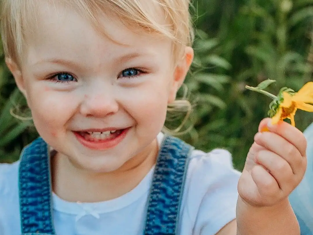 Hair, Skin, Smile, Hand, Plant, People In Nature, Leaf, Green, Azure, Baby & Toddler Clothing, Sleeve, Happy, Grass, Iris, Finger, Toddler, Summer, T-shirt, Baby, Electric Blue, Person, Joy