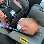 Comfort, Gesture, Baby Carriage, Car Seat, Baby, Toddler, Baby In Car Seat, Child, Auto Part, Automotive Design, Thumb, Baby Products, Vehicle Door, Bag, Service, Baby & Toddler Clothing, Seat Belt, Steering Wheel, Electric Blue, Person