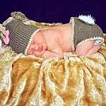 Cheek, Skin, Eyes, Comfort, Baby & Toddler Clothing, Textile, Baby Sleeping, Baby, Toddler, Furry friends, Peach, Fashion Accessory, Headband, Linens, Baby Products, Sitting, Room, Beanie, Child, Portrait Photography, Person, Headwear