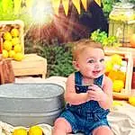 Smile, Photograph, Orange, Yellow, Happy, Plant, Baby & Toddler Clothing, Baby, Natural Foods, Leisure, Morning, Fun, Summer, Chair, Toddler, Citrus, Toy, Child, Fruit, Person