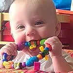 Nose, Cheek, Head, Baby Playing With Toys, Happy, Baby, Fun, Toddler, Child, Toy, Baby & Toddler Clothing, Baby Products, Sweetness, Event, Room, Baby Toys, Play, Smile, Sitting, Confectionery, Person