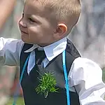 Photograph, School Uniform, Dress Shirt, Sleeve, Gesture, Tie, Happy, Collar, People In Nature, Formal Wear, Toddler, Uniform, Event, Grass, Electric Blue, Jewellery, Child, Tradition, White-collar Worker, Tuxedo, Person