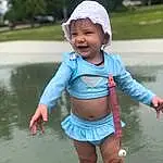 Water, Skin, Smile, Eyes, Facial Expression, Sleeve, Happy, Baby & Toddler Clothing, People In Nature, Pink, Leisure, Finger, Grass, Fun, Toddler, Waist, Recreation, T-shirt, Thigh, Electric Blue, Person, Headwear