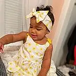 Skin, Baby & Toddler Clothing, Baby, Sleeve, Happy, Toddler, Event, Comfort, Baby Products, Fun, Child, Pattern, Headband, Room, Sitting, Headpiece, Day Dress, Tradition, Hair Accessory, Linens, Person, Headwear