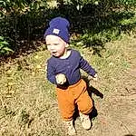 Plant, People In Nature, Grass, Toddler, Hat, Tree, Baby & Toddler Clothing, Cap, Baby, Soil, Landscape, Baseball Cap, Recreation, Electric Blue, Sitting, Garden, Child, Sun Hat, Fun, Play, Person, Headwear