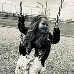 Swing, White, Outdoor Play Equipment, Black, Black-and-white, Public Space, Child, Playground, Hairstyle, Monochrome, Fun, Grass, Smile, Blond, Black & White, Photography, Design, Long Hair, City, Toddler, Person, Joy