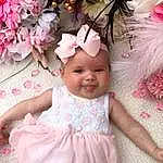 Skin, Plant, White, Flower, Dress, Textile, Happy, Petal, Pink, Baby & Toddler Clothing, Magenta, Smile, Headpiece, Toddler, Beauty, Baby, Flower Arranging, Child, Embellishment, Event, Person, Joy, Headwear