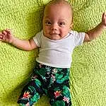 Skin, Head, Smile, Baby & Toddler Clothing, People In Nature, Textile, Sleeve, Standing, Happy, T-shirt, Baby, Collar, Grass, Comfort, Toddler, Child, Pattern, Linens, Barefoot, Fun, Person
