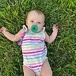 Skin, People In Nature, Plant, Leaf, Baby & Toddler Clothing, Happy, Baby, Iris, Finger, Pink, Grass, Toddler, Meadow, Terrestrial Plant, Fun, Thumb, Grassland, Pattern, Groundcover, Spring, Person