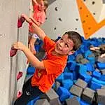 Climbing Hold, Photograph, Climbing, Leisure, Recreation, Sports, Fun, Electric Blue, Competition Event, Climbing Harness, Happy, Elbow, Rock-climbing Equipment, Rope, Balance, Shorts, Adventure, Competition, Smile, Person, Blurred, Joy
