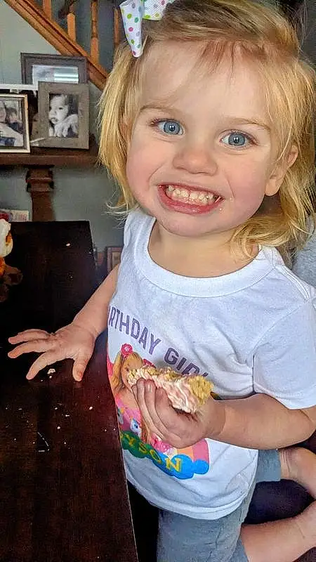 Cheek, Smile, Chin, Hairstyle, Picture Frame, Eyes, Facial Expression, Sleeve, Iris, Gesture, Happy, Finger, T-shirt, Fun, Toddler, Blond, Child, Cooking, Bangs, Person, Joy
