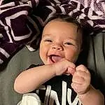 Cheek, Skin, Outerwear, Smile, Eyebrow, Flash Photography, Sleeve, Comfort, Baby, Baby & Toddler Clothing, Happy, Gesture, Iris, Cool, Toddler, Thumb, Child, Baby Laughing, Eyelash, Person
