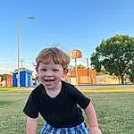 Sky, Smile, Plant, Tartan, Sleeve, Happy, Street Light, Tree, Leisure, Fun, Public Space, Grass, People In Nature, Toddler, Plaid, T-shirt, Baby & Toddler Clothing, Child, Lawn, Recreation, Person, Joy