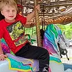 Horse, Carousel, Leisure, Fun, Working Animal, Summer, Recreation, Tree, Event, Toddler, Horse Tack, Amusement Ride, Happy, Nonbuilding Structure, Bridle, Amusement Park, Vacation, Sitting, Person, Joy