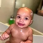 Nose, Cheek, Baby Bathing, Skin, Lip, Eyes, Smile, Mouth, Fluid, Plumbing Fixture, Bathroom, Iris, Bathing, Chest, Plumbing, Baby, Thumb, Toddler, Eyelash, Stomach, Person, Joy