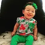 Child, Toddler, Green, Baby, Skin, Head, Baby & Toddler Clothing, Sleeve, Sitting, Design, Baby Products, Smile, Neck, Child Model, Play, Pattern, T-shirt, Happy, Baby Laughing, Hair Accessory, Person, Joy, Headwear