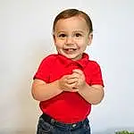 Clothing, Face, Cheek, Joint, Smile, Arm, Facial Expression, Flash Photography, Sleeve, Happy, Standing, Gesture, Finger, T-shirt, Baby & Toddler Clothing, Thumb, Elbow, Toddler, Fun, Person, Joy