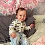 Face, Cheek, Skin, Hairstyle, Smile, Eyes, Leg, Comfort, Human Body, Textile, Sleeve, Couch, Lap, Baby & Toddler Clothing, Pink, Happy, Thigh, Toddler, Beauty, Person, Joy