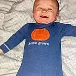 Clothing, Outerwear, Baby & Toddler Clothing, Textile, Smile, Sleeve, Orange, Jersey, T-shirt, Toddler, Sportswear, Pattern, Woolen, Wool, Electric Blue, Baby, Thumb, Vegetable, Linens, Person