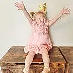 Smile, Dress, Flash Photography, Happy, Pink, Wood, Baby & Toddler Clothing, Knee, Thigh, Day Dress, Fashion Design, Headpiece, Human Leg, Toddler, Room, Peach, Pattern, Fashion Accessory, Sitting, Child, Person, Joy